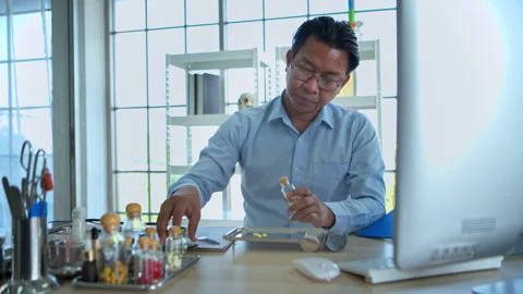 The pharmacist is arranging medications on sorting trays and counting Stock Footage 339057380