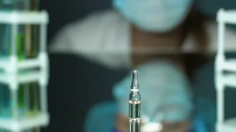 Pharmacist checking medication vial in l... | Stock Video | Pond5
