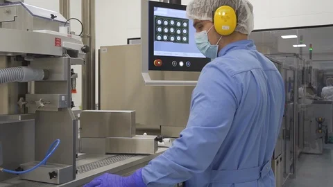 Pharmacist control pharmaceutical manufacturing process at drug factory using Video stock 120419057