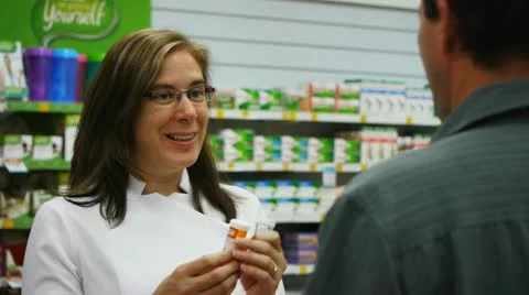 Pharmacist counselling customer Stock Footage