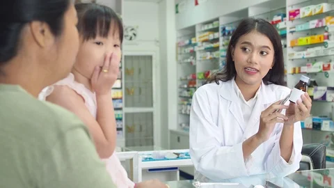 Pharmacist explaining the medication to patient in drug store Stock Footage 108646471