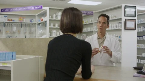 Pharmacist explaining prescription Stock Footage 79976215