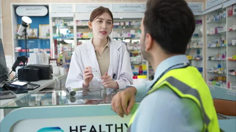 The pharmacist explains the use of medicines to the engineers Stock Footage 308357124