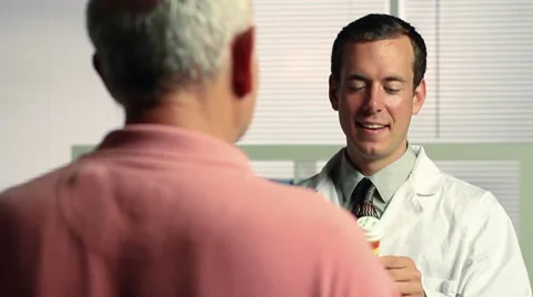 Pharmacist giving prescription to patient Stock Footage