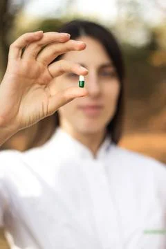 Pharmacist holding a pill Stock Photos