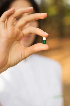 Pharmacist holding a pill Stock Photos