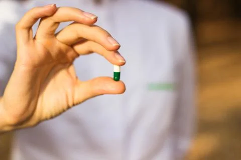 Pharmacist holding a pill Stock Photos