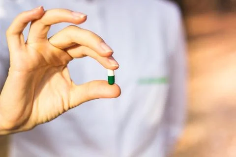 Pharmacist holding a pill Stock Photos