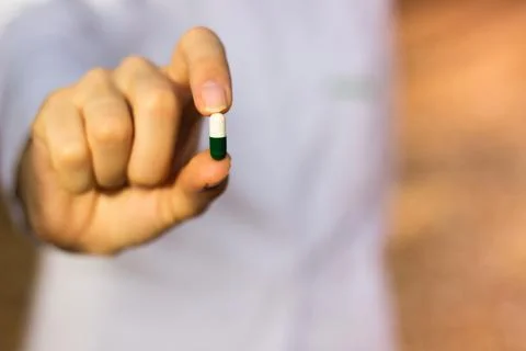 Pharmacist holding a pill Stock Photos