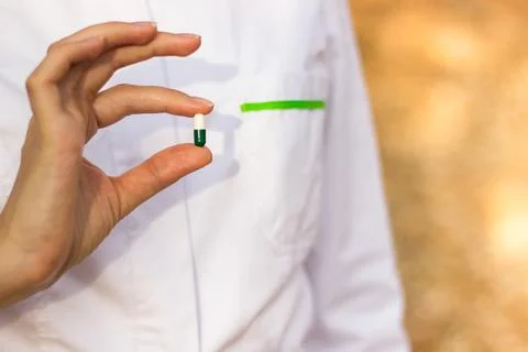 Pharmacist holding a pill Stock Photos