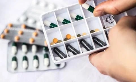 Pharmacist holding a pill Stock Photos