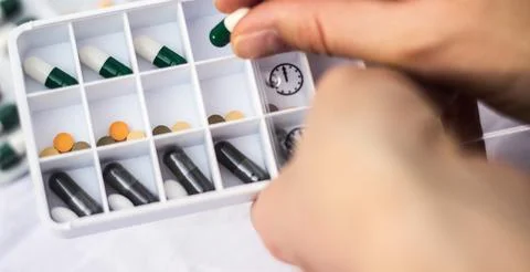 Pharmacist holding a pill Stock Photos