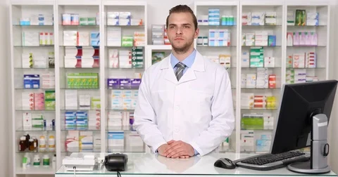 Pharmacist Man Looking Sideways Posing a Positive Yes Answer Pharmacy Shop Store Stock Footage 73589660