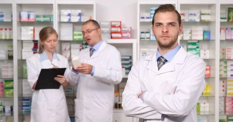 Pharmacist Man Posing Serious Look Camera Colleague Team Activity Pharmacy Store Stock Footage 81453844