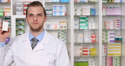 Pharmacist Man Presentation Drug Box Medicine Looking Camera in Pharmacy Store Stock Footage 77009540
