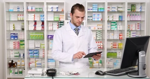 Pharmacist Man Working Digital Tablet Medicine Pills Inventory Pharmacy Activity Stock Footage 77009790