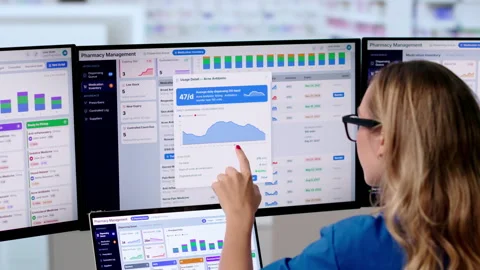 Pharmacist Managing Medication Inventory Using Software Stock Footage 347901805
