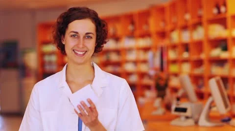 Pharmacist in pharmacy holding thumbs up Stock Footage