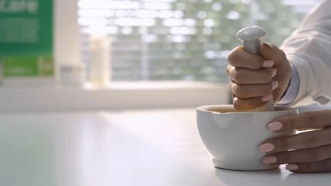 Pharmacist preparing medicine with mortar and pestle Stock Footage 87904337