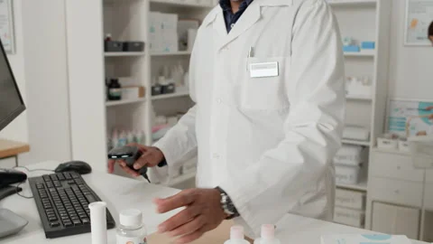 Pharmacist Preparing Order and Scanning Medications in Pharmacy Stock Footage 334862988