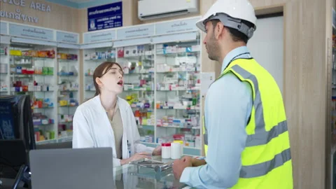 The pharmacist provides medicine to the engineers Stock Footage 308355418