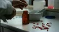 pharmacist puts capsules in a jar HD Footage