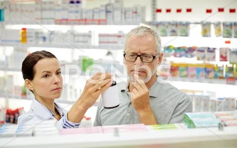 Pharmacist showing drug to senior man at pharmacy Stock Photos