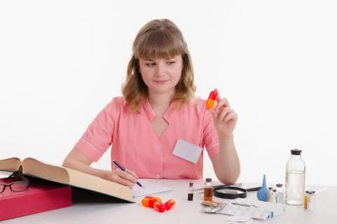 Pharmacist studying composition pills Stock Photos