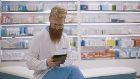Pharmacist using a tablet-pc scrolling with her finger on the touchscreen Stock Footage 126527361