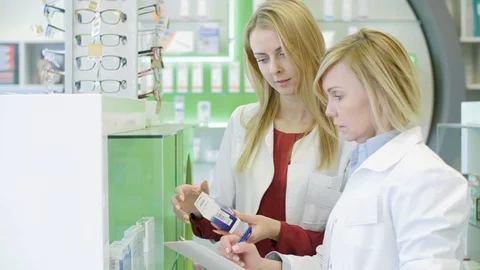 Pharmacists working together in pharmacy Stock Footage 88991975