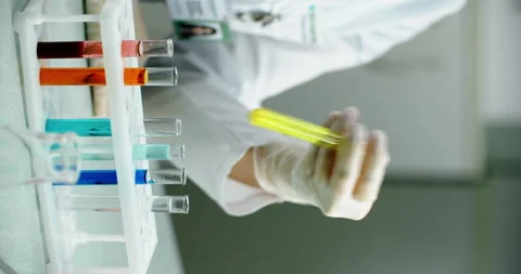 Pharmacology concept. Testing. Hands of a lab assistant with flask. Laboratory Stock Footage 164613525