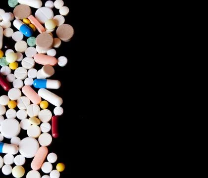 Pharmacy background on a dark table. Levitation pills. Tablets on a dark back Stock Photos