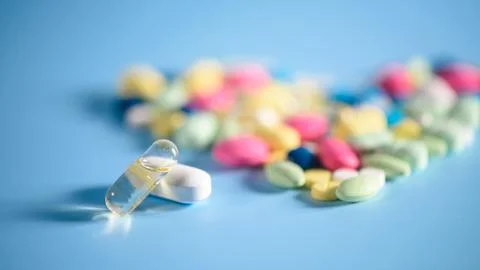 Pharmacy background on a  table. Tablets on a blue background. Pills. Medicin Stock Photos