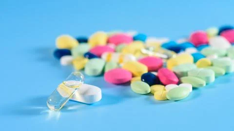 Pharmacy background on a  table. Tablets on a blue background. Pills. Medicin Stock Photos