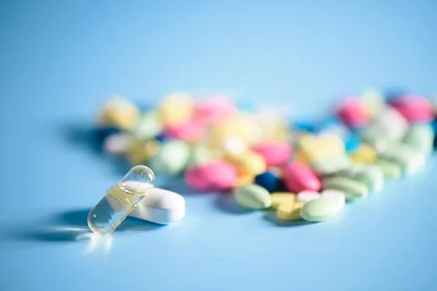 Pharmacy background on a  table. Tablets on a blue background. Pills. Medicin Stock Photos