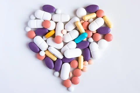Pharmacy background on a white table. Pills and capsules. Stock Photos