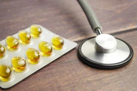 Pharmacy background on a white table. Tablets on a wooden background. Pills.. Stock Photos