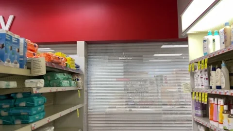 Pharmacy closed pick up sign gate pulled down in store New York City NYC Video stock 162993834