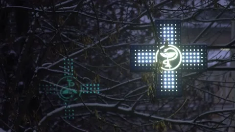 Pharmacy cross, emblem flickers in the dark. the pharmacy lamps are lit Stock Footage 143418552