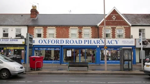 Pharmacy in England with heavy street traffic Stock Footage 58471853