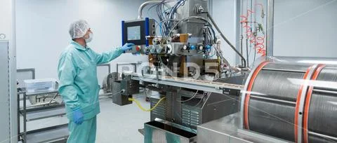 Pharmacy industry factory man worker in protective clothing in sterile working Stock Photos