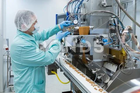 Pharmacy industry factory man worker in protective clothing in sterile working Stock Photos
