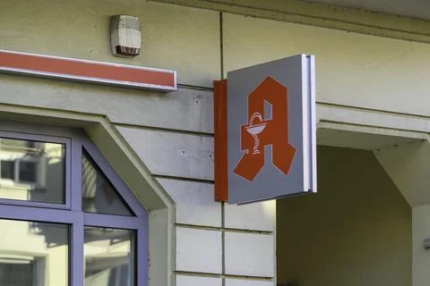 The pharmacy logo on a building wall Stock Photos