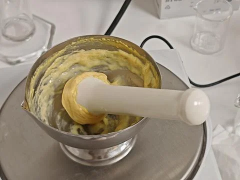 Pharmacy professional compounding cream with mortar and pestle, angled view Stock Photos