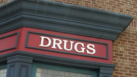 Pharmacy Sign on Brick Corner Building in Light Rain with Wet Facade Details Stock Footage 334699280