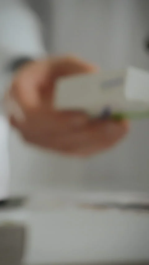 Pharmacy worker hands over medicines to customer in a close-up view at a loc Stock Footage 331677850