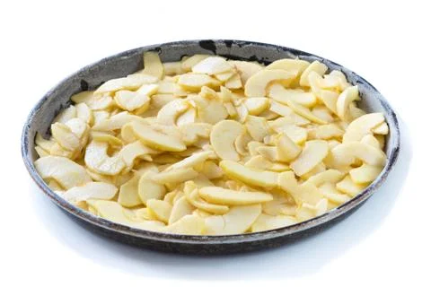Phase of preparation of an apple pie. Baking tin with apples cut Stock Photos