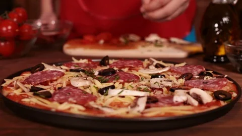 Phases of making a pizza - putting on the chopped chives Stock Footage 80104189