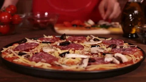 Phases of making a pizza - putting on the sliced olives Stock Footage 80104165