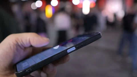 The Phenomenon of Mobile Phone Usage During Nighttime in a Lively Urban Stock Footage 286975972